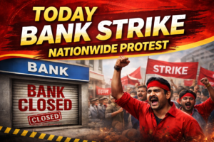 Today bank strike in India showing closed bank branch and protesters holding strike banners